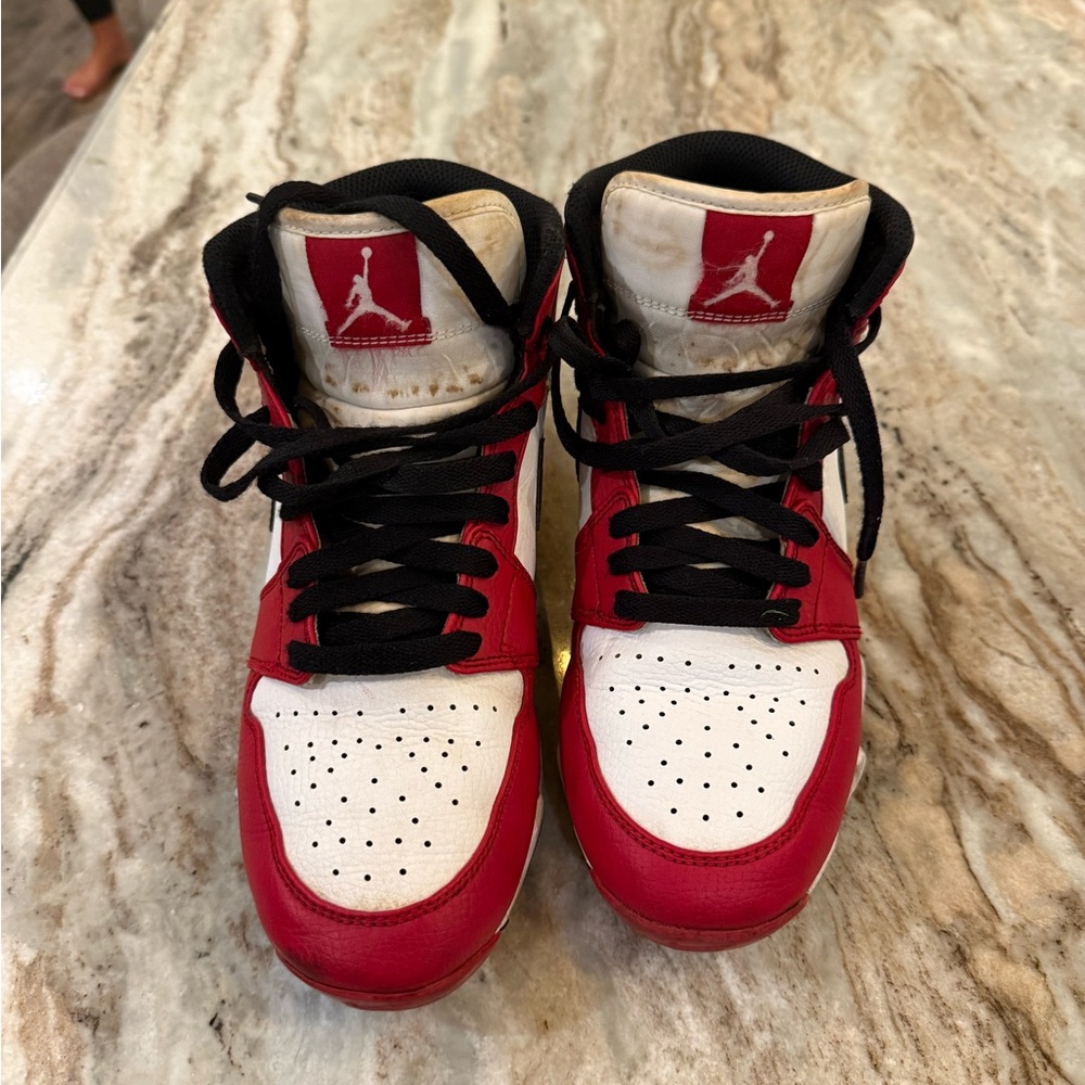 Kids Red and White High-Top kids football cleats.